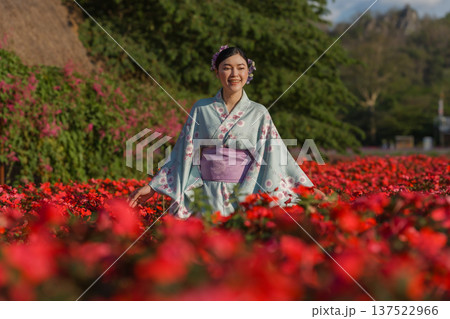woman in yukata (kimono dress) with flower blooming in garden 137522966