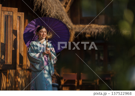 woman in yukata (kimono dress) holding umbrella woman in yukata (kimono dress) holding umbrella 137522968
