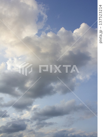 It's a blue sky with atmospheric puffy clouds. 137523214