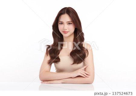 A beautiful young Asian woman with clean, fresh skin against a white background. Skincare, facial treatment, cosmetology, beauty, and spa. An elegant portrait of an Asian woman. 137524673