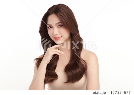 A beautiful young Asian woman with clean, fresh skin against a white background. Skincare, facial treatment, cosmetology, beauty, and spa. An elegant portrait of an Asian woman. 137524677