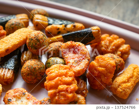 Assorted Japanese Rice Crackers and Snacks Mix Arare Senbei with Seaweed on White Plate - Traditional Asian Savory Snack Food Assorted Japanese Rice Crackers and Snacks Mix Arare Senbei with Seaweed on White Plate - Traditional Asian Savory Snack Food 137524766