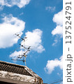 Old TV Antenna on Roof with Blue Sky and White Clouds Background 137524791