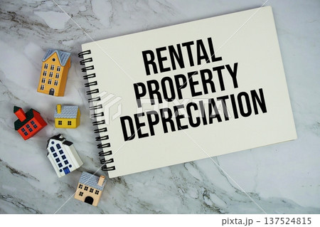 Rental Property Depreciation text written on notepad with house model on marble background Rental Property Depreciation text written on notepad with house model on marble background 137524815