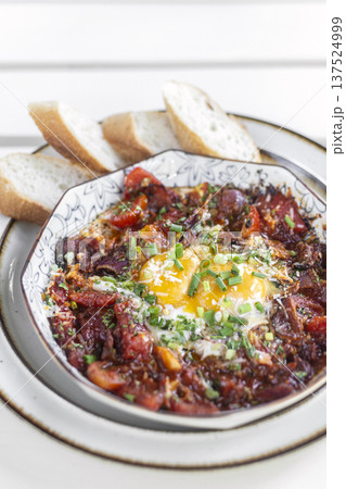 Shakshuka brunch dish on white table at outdoors restaurant in israel Shakshuka brunch dish on white table at outdoors restaurant in israel 137524999