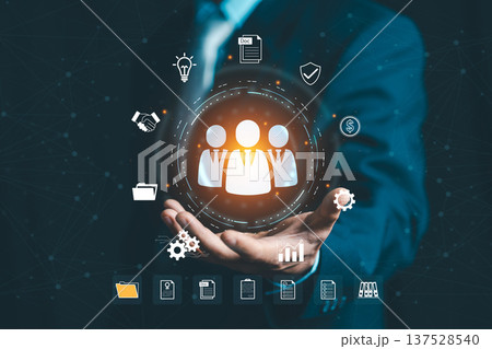 Businessman presenting HR management icons and team leader symbol. Concept of human resources, recruitment, leadership, organizational structure, and teamwork. Businessman presenting HR management icons and team leader symbol. Concept of human resources, recruitment, leadership, organizational structure, and teamwork. 137528540