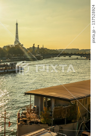 Eiffel Tower and Pont Alexandre III over Seine River with boat during a golden sunset in Paris, France Eiffel Tower and Pont Alexandre III over Seine River with boat during a golden sunset in Paris, France 137528924