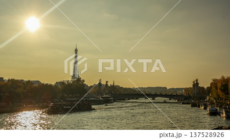 Paris cityscape with Eiffel Tower, Seine River, Pont Alexandre III, and tourist boats cruising at sunset Paris cityscape with Eiffel Tower, Seine River, Pont Alexandre III, and tourist boats cruising at sunset 137528926