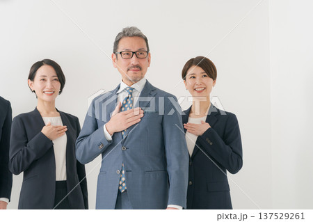 胸に手を当てる複数のビジネスマン 137529261