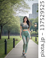 街中の緑地の遊歩道を歩くスポーツウエアを着た女性（下視線右配置） 137529525