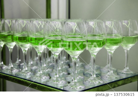 Green cocktails filling glasses arranged for celebration event Green cocktails filling glasses arranged for celebration event 137530615
