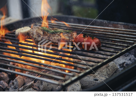 BBQ Barbecue grilled meat stick on fire flame with hot charcoal cooking outside. Beef grilling picnic outdoor with smoke bacon spicy sausage for party. Grill pork bbq on fire flame 137531517