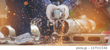 Banner Men hands wear protective glove Hot flame metal work cut fire iron workshop. Locksmith cut metal process. Construction Worker hands using Welding machinery iron metal sparking with copy space Banner Men hands wear protective glove Hot flame metal work cut fire iron workshop. Locksmith cut metal process. Construction Worker hands using Welding machinery iron metal sparking with copy space 137531548