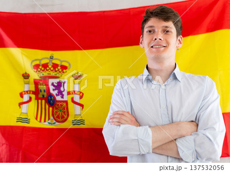 Young guy posing in front of flag of Spain Young guy posing in front of flag of Spain 137532056