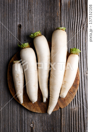 Fresh daikon radish arranged neatly on wooden table 137532108