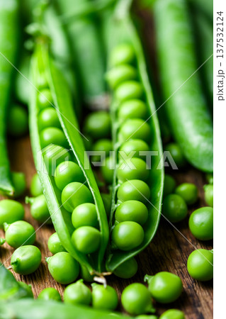 Fresh green peas in pods forming natural food background Fresh green peas in pods forming natural food background 137532124