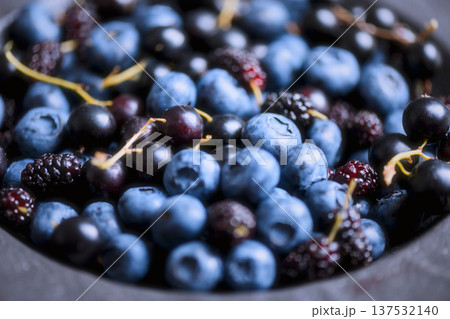 Macro view of blueberries and mulberries filling the frame 137532140