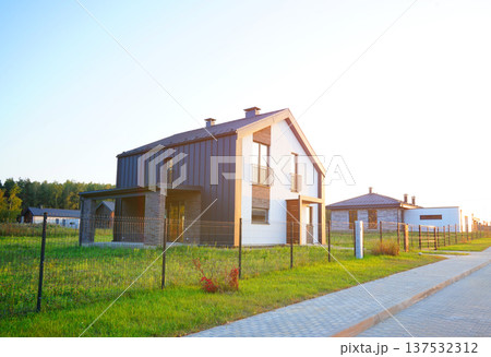 Suburban residential neighborhood, home on street, fence of single family home. Suburb family house. 137532312