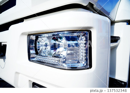 Headlight of truck close up. Close view of white truck headlight showing details of design  137532348