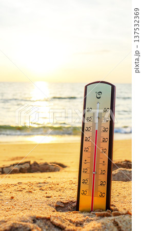 Thermometer on sunset sea beach in tropical. Extremely hot day Thermometer measuring air temperature Thermometer on sunset sea beach in tropical. Extremely hot day Thermometer measuring air temperature 137532369