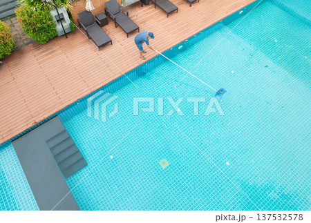 Pool maintenance with scoop net to capturing the leaves on the surface of pool. 137532578