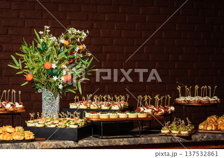Elegant Canape Buffet with Citrus Floral Centerpiece Elegant Canape Buffet with Citrus Floral Centerpiece 137532861