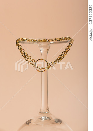 Luxury Chain On Neutral Background. Minimalist Gold Necklace Highlighted Against Warm Studio Setting Luxury Chain On Neutral Background. Minimalist Gold Necklace Highlighted Against Warm Studio Setting 137533326