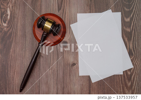 Gavel and blank papers on wooden table for legal proceedings Gavel and blank papers on wooden table for legal proceedings 137533957