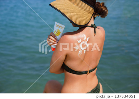 Woman enjoying Mediterranean beach lifestyle with sunscreen lotion and suncream sun pattern Woman enjoying Mediterranean beach lifestyle with sunscreen lotion and suncream sun pattern 137534051