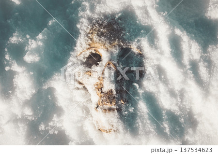 A human skull under snow. An eerie concept, buried in cold snow. Archaeological excavations, human remains. Dark winter concept of death, accident. Skull close-up. A human skull under snow. An eerie concept, buried in cold snow. Archaeological excavations, human remains. Dark winter concept of death, accident. Skull close-up. 137534623