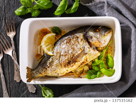 Baked whole dorada fish with lemon and basil Baked whole dorada fish with lemon and basil 137535162