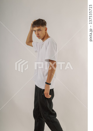 Handsome young guy in stylish clothes on white Handsome young guy in stylish clothes on white 137535715