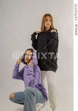 Two beautiful young girls in stylish clothes on a Two beautiful young girls in stylish clothes on a 137535775