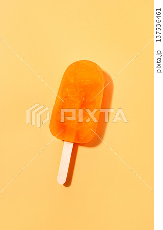 Orange ice cream lying on an orange background. 137536461