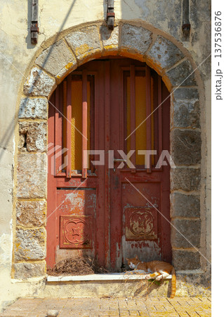 Old wooden door with stone arch and cat in Rhodes Greece Old wooden door with stone arch and cat in Rhodes Greece 137536876