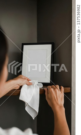 Adult Hands Dusting Black Picture Frame Adult Hands Dusting Black Picture Frame 137536982