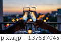 Champagne Toast at Sunset on City Balcony 137537045