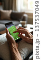 Hands Using Smartphone to Watch Soccer at Home 137537049