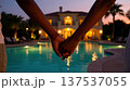 Couple Holding Hands by Pool at Luxury Villa 137537055
