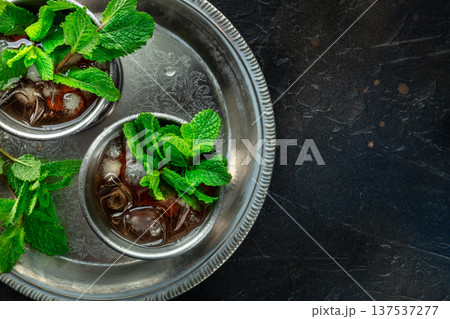 Mint Julep in the Kentucky Derby classic silver glass, with fresh mint leaves 137537277