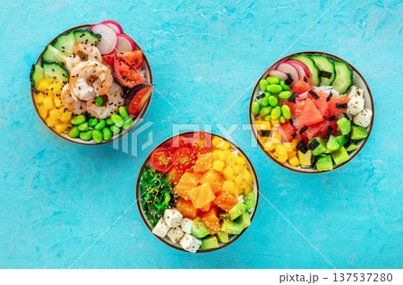 Poke bowl assortment. Rice with salmon, shrimps, and grapefruit Poke bowl assortment. Rice with salmon, shrimps, and grapefruit 137537280