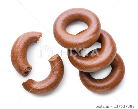 Cocoa dried bagels and two halves close up on a white. Top view 137537395