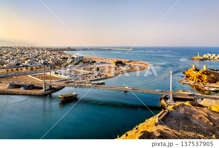 Aerial view of the iconic Al Ayjah suspension bridge and historic lighthouse over the creek in the coastal city of Sur, Oman, Middle East 137537905
