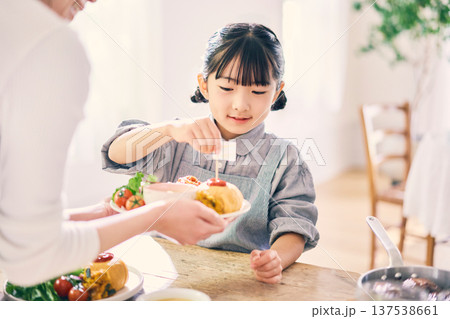 食事の手伝いをする女の子 137538661