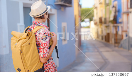 Woman strolls through colorful streets of Spanish coastal town 137538697