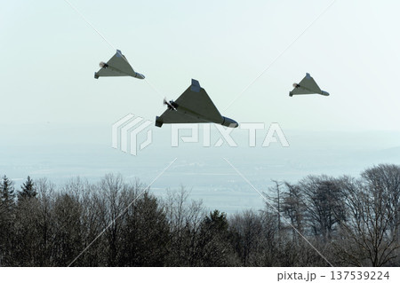 Military unmanned kamikaze drones perform attack and patrol in the sky. 137539224
