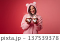 Girl in pink kigurumi holding hot drinks, cozy Valentines Day mood and cute lifestyle concept 137539378