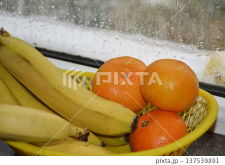 A basket of ripe fruit: bananas and tangerines. A basket of ripe fruit: bananas and tangerines. 137539891