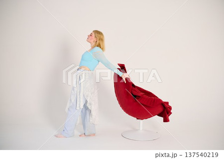 Reflective motion blonde woman walking near chair 137540219