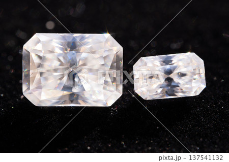 Two Sparkling Clear Emerald Cut Diamonds Displayed Side by Side on Black Background Showing Brilliant Facets and High Clarity Gemstones Two Sparkling Clear Emerald Cut Diamonds Displayed Side by Side on Black Background Showing Brilliant Facets and High Clarity Gemstones 137541132